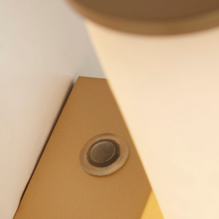 Close-up of the Wales light's brushed gold bracket and marble resin shade end
