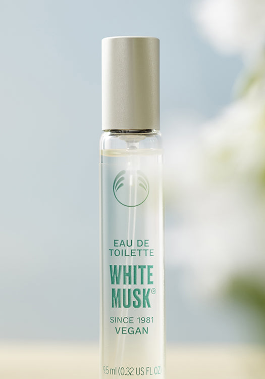 White Musk eau de toilette bottle with a blurred natural background